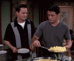 A man serving egg to his friend