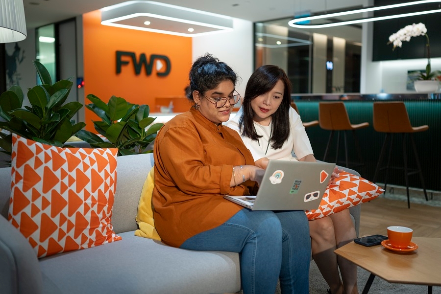 2 female colleagues talking about work in the office in the evening