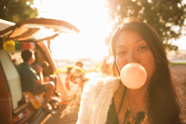 Woman blow a bubblegum outdoors