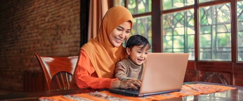 Mother and son having a video call on a laptop in the living room of their home
